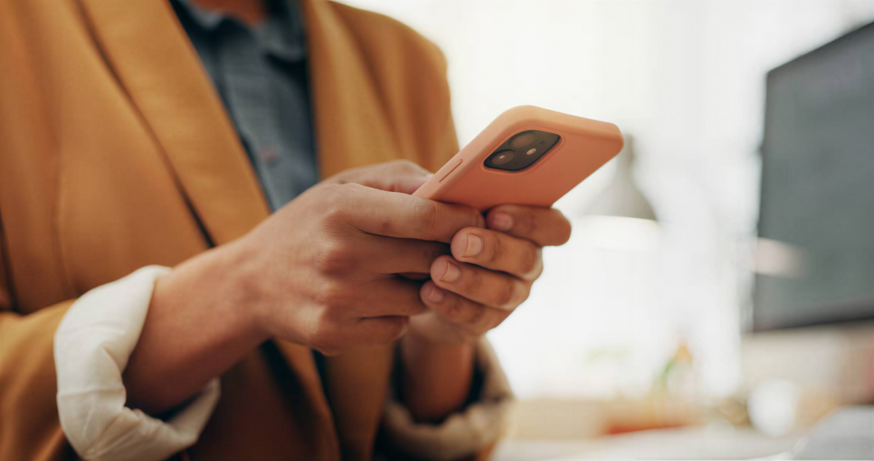 Person holding an orange smartphone